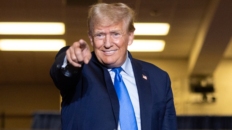 Donald Trump, smiling and pointing a finger