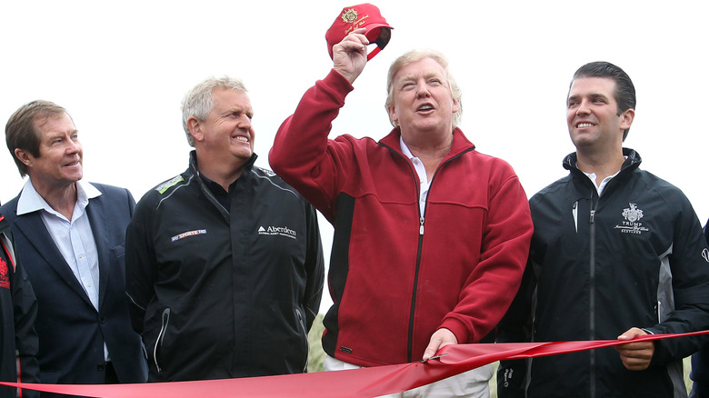 Donald Trump (2nd R) opens The Trump International Golf Links Course as (L-R) George O'Grady, Colin Montgomerie and Don Trump Jr look on, on July 10, 2012 in Balmedie, Scotland.