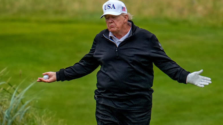 Donald Trump reacts as he plays a round of golf at Trump Turnberry golf course during his visit to the UK on July 27, 2025 in Turnberry, Scotland.