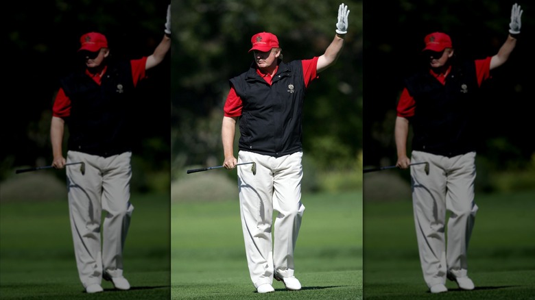 Donald Trump wearing a weird vest and red shirt while golfing at the AT&T Pebble Beach Pro-Am Tournament in 2005.