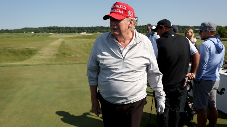 Donald Trump looks on from the third hole during the pro-am prior to the LIV Golf Invitational - DC at Trump National Golf Club on May 25, 2023 in Sterling, Virginia.
