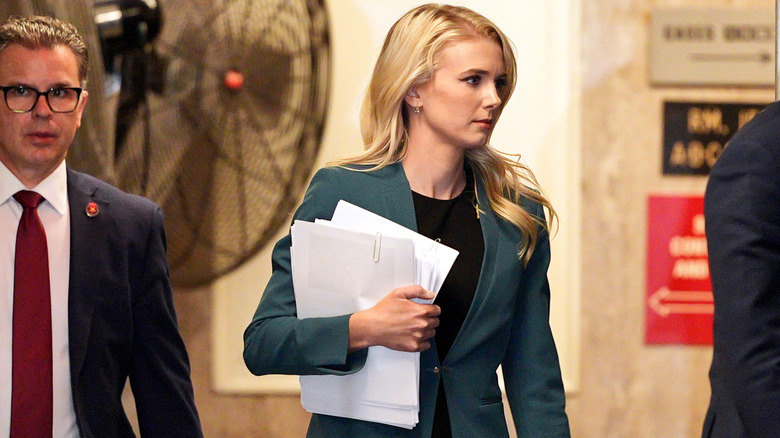 Natalie Harp holding a stack of papers