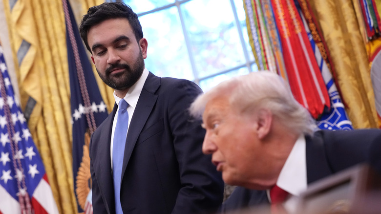Zohran Mamdani looking at Donald Trump as they address the press in the Oval Office.