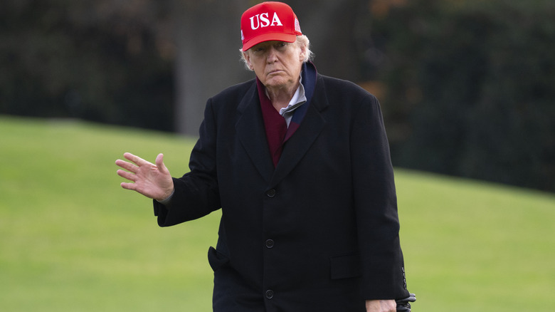 Donald Trump waves to reporters.