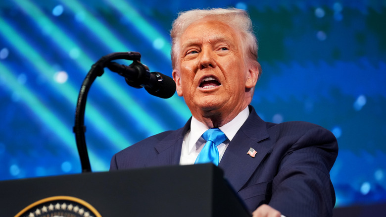 Donald Trump speaking into a microphone