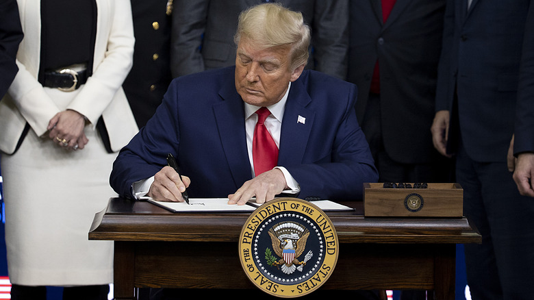 Donald trump signing documents