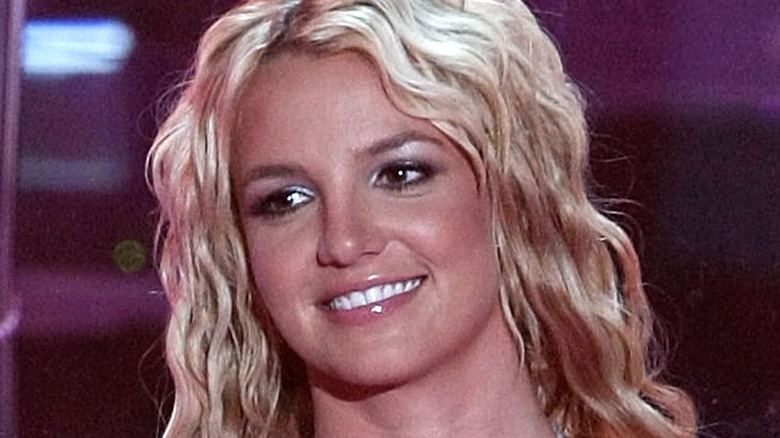 Britney Spears smiles, looking to the left