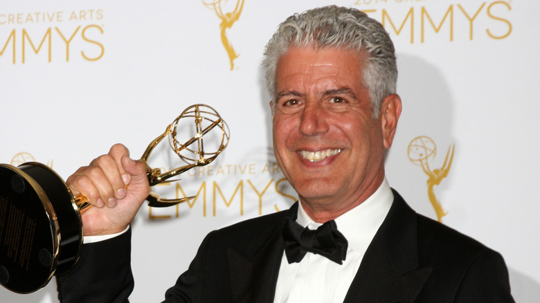 Anthony Bourdain holding Emmy