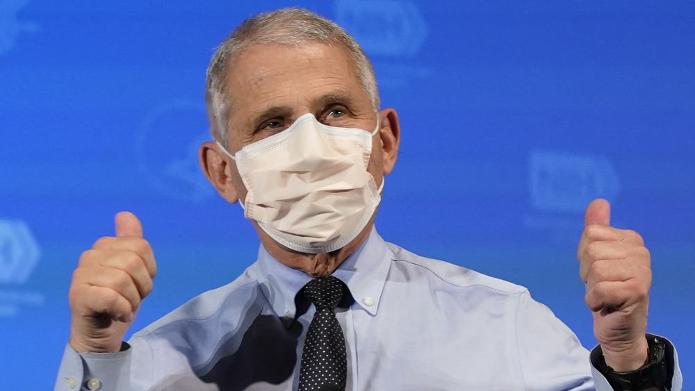 Dr. Fauci wearing a mask with thumbs up at a press briefing 