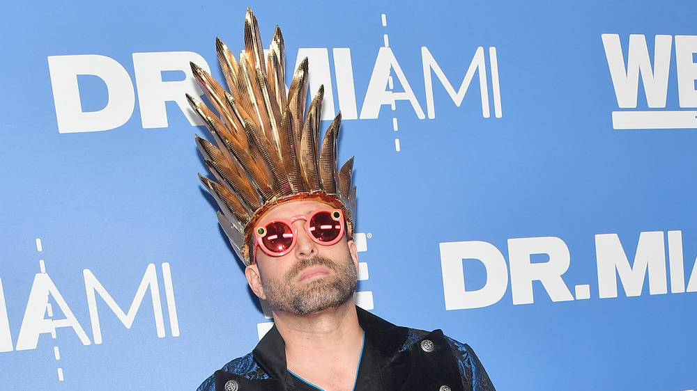 Dr. Miami in a crown and sunglasses at an event 