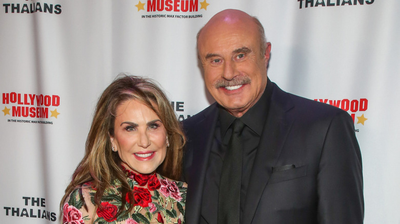 Dr. Phil and Robin McGraw smile while posing at an event together in 2022