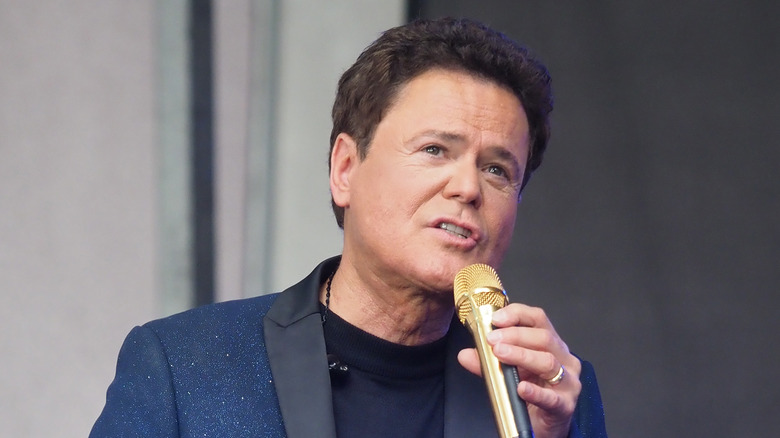 Donny Osmond singing on stage