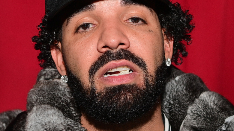 Drake wearing a dark hat