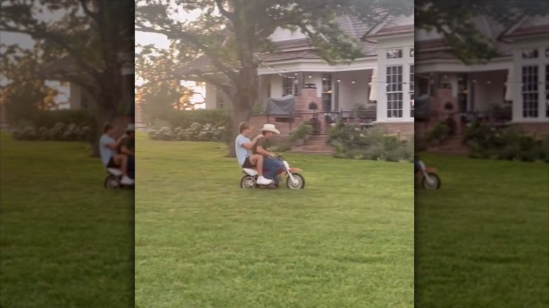 Duke and Drake Gaines riding a small bike