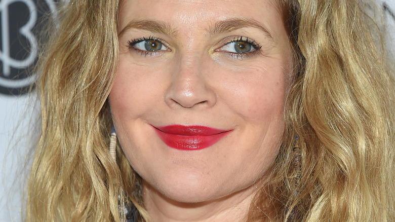 Drew Barrymore poses in red lipstick