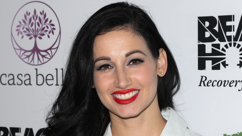 Amie Harwick smiles in red lipstick