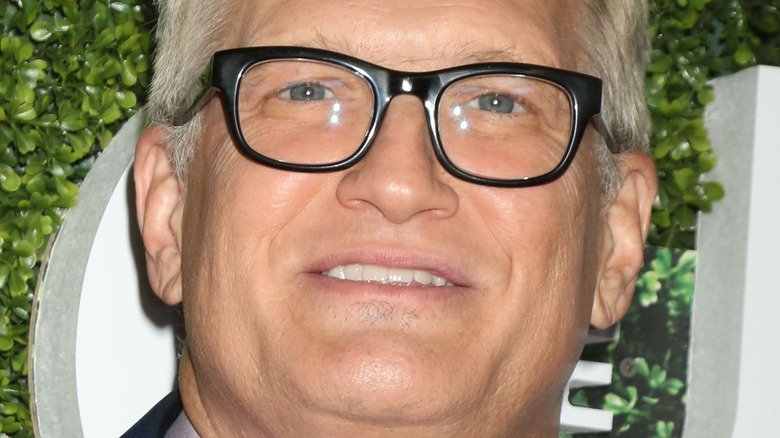 Drew Carey poses in black-frame glasses