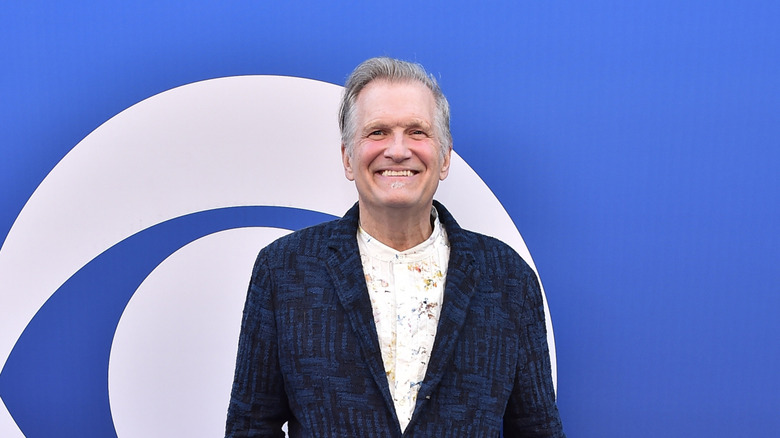 Drew Carey poses on a red carpet