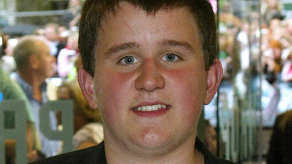 A young Harry Melling smiling 