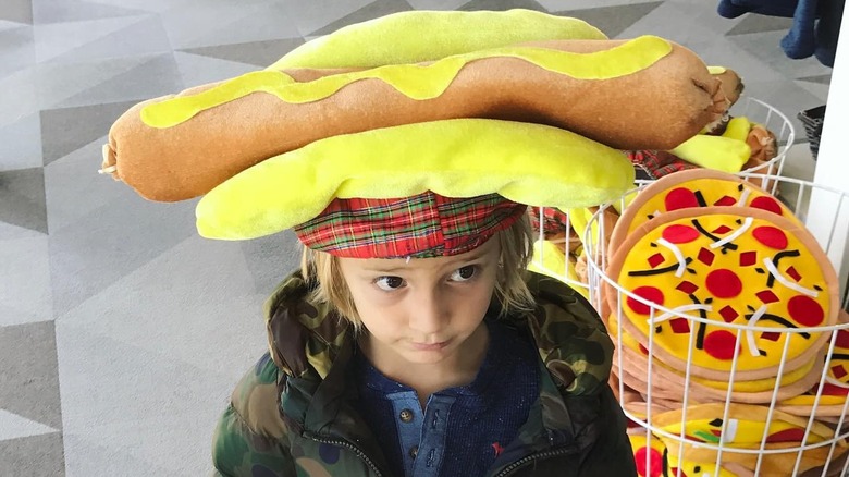 Duke wears a stuffed hot dog hat.