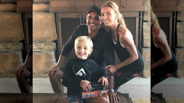 Duke smiles with his parents at home.