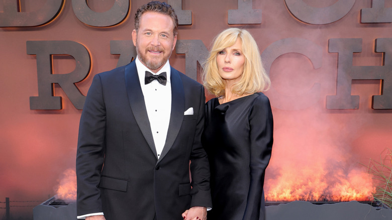 Kelly Reilly and Cole Hauser posing together while holding hands at an event for Dutton Ranch