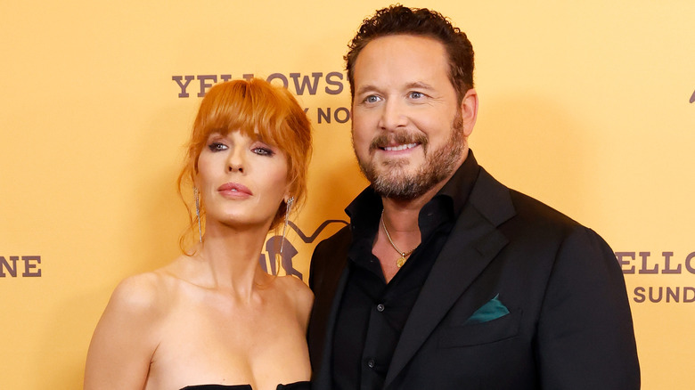Kelly Reilly and Cole Hauser posing together on the red carpet at a Yellowstone event