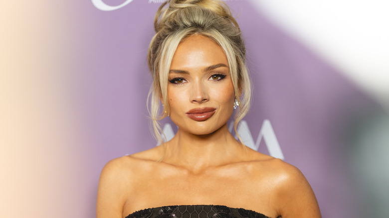 Natalie Alyn Lind wearing a strapless black dress