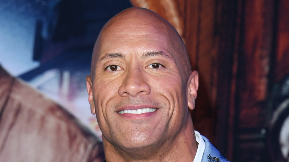 Dwayne Johnson posing at a red carpet event