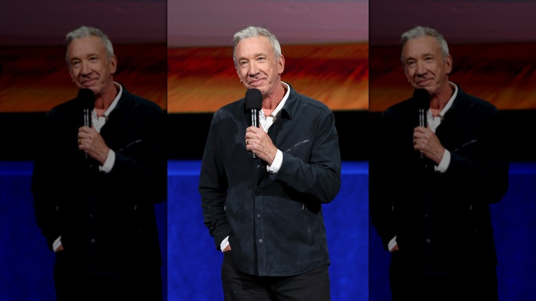 Tim Allen holding a mic