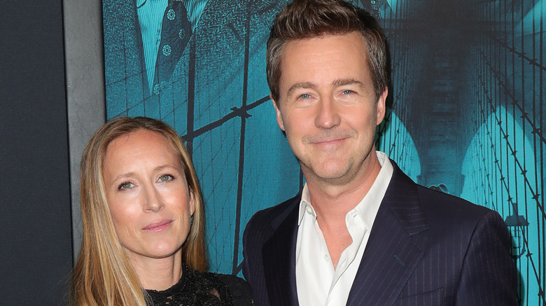 Edward Norton and Shauna Robertson smiling on red carpet
