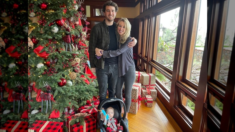 Billy Evans and Elizabeth Holmes hugging in front of a Christmas tree