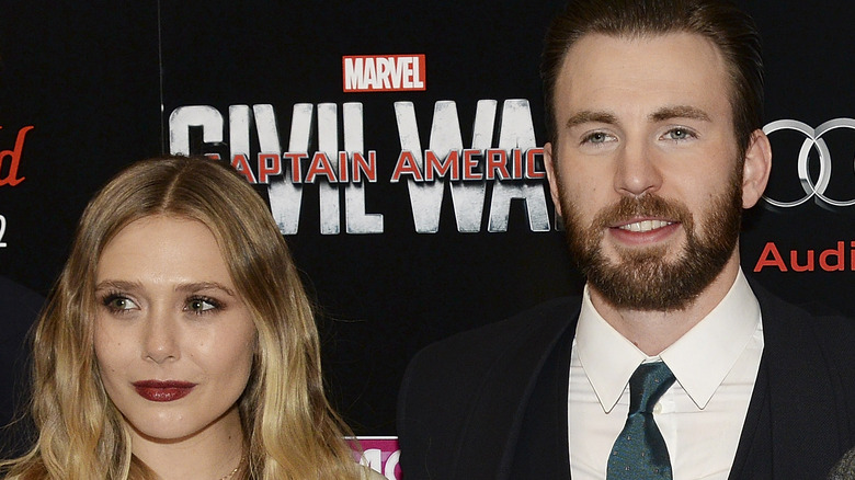Elizabeth Olsen and Chris Evans signing autographs 2014