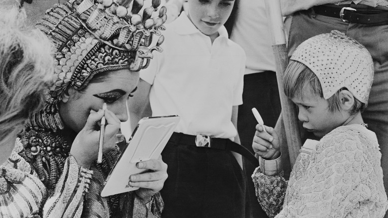 Elizabeth Taylor doing her own makeup on the set of "Cleopatra."