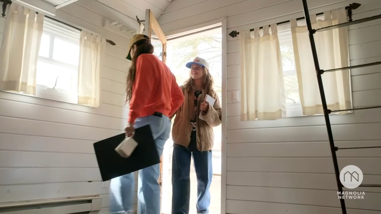 Joanna and Ella Gaines entering a cottage