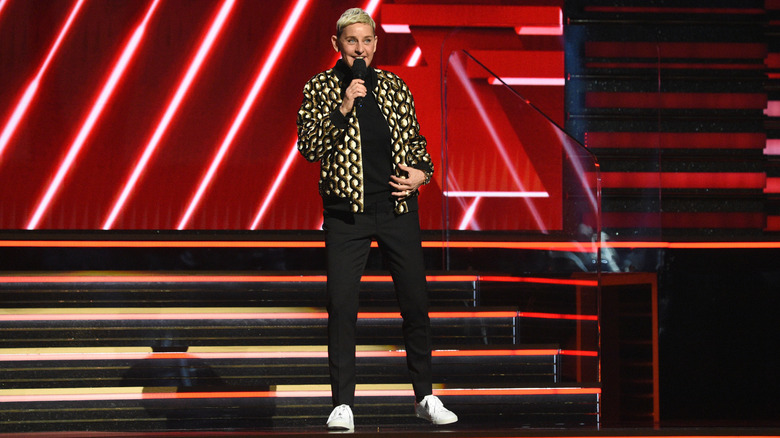 Ellen DeGeneres talks into a microphone on stage at the 2020 Grammy Awards