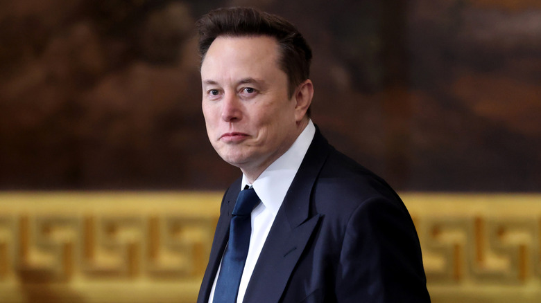 Elon Musk wearing a suit
