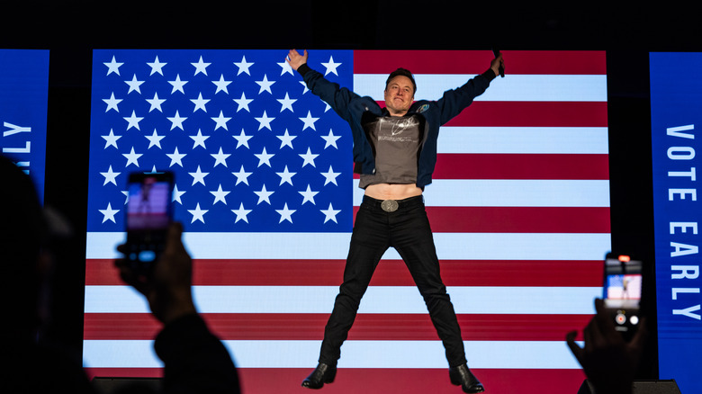 Elon Musk showing stomach as he leaps on stage