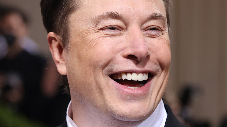 Elon Musk black tux laughing