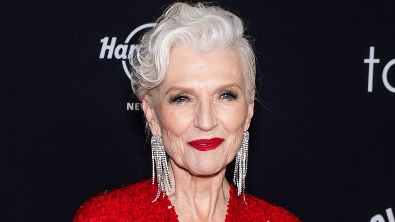 Maye Musk wearing red with a bright red lipstick