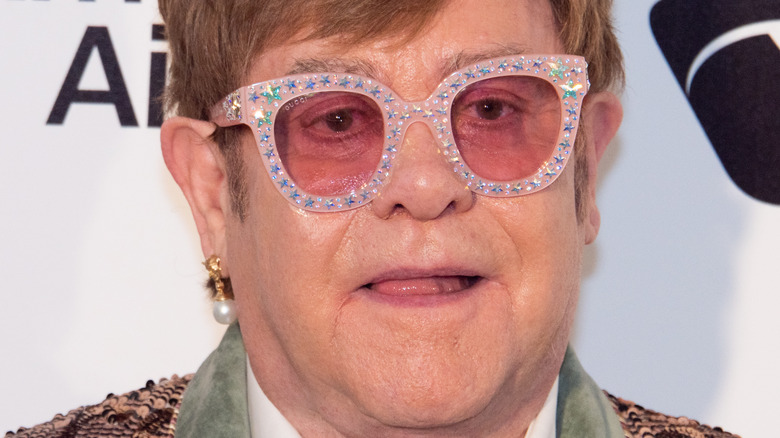 Elton John reacts on the red carpet