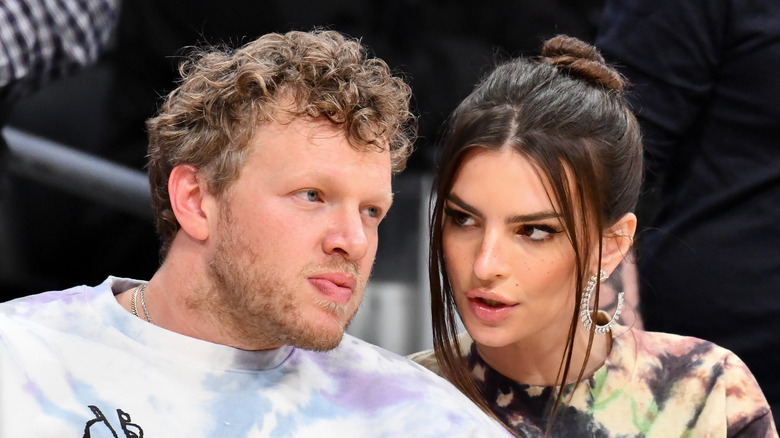 Emily Ratajkowski and her husband Sebastian Bear-McClard watch a basketball game