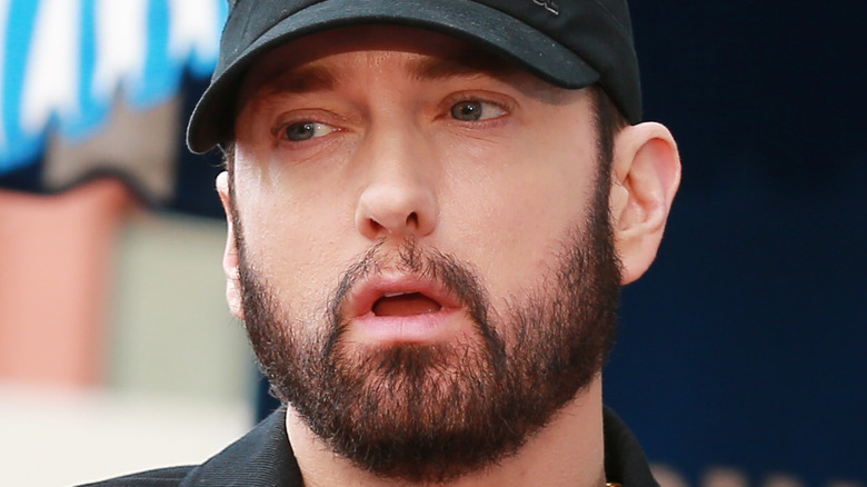 Eminem wearing a black hat