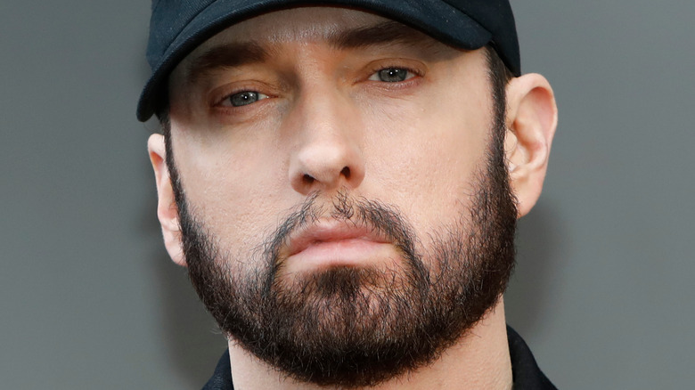 Eminem wearing a black hat