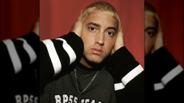 Eminem with hands on side of head