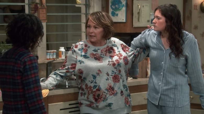 Emma Kenney wearing pajamas and frowning at Roseanne Barr while filming "Roseanne"