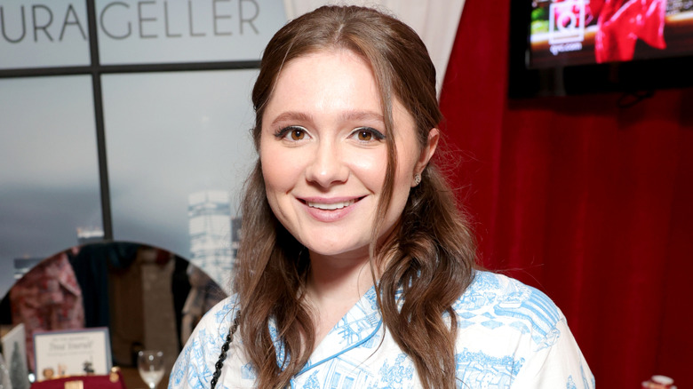 Shameless' Emma Kenney smiling and wearing blue and white patterned top