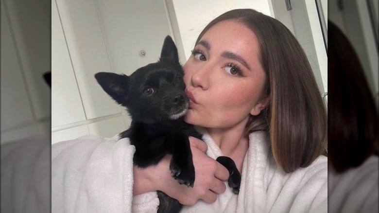 Emma Kenney kissing her dog Prince