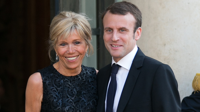 Brigitte Macron and Emmanuel Macron walking