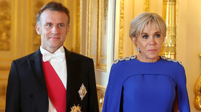 Emmanuel and Brigitte Macron standing together
